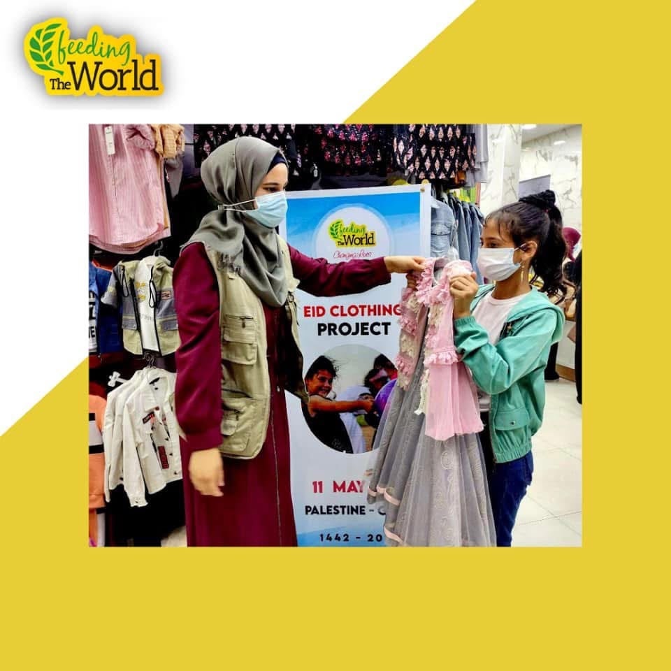 Eid Clothing Project in Palestine — volunteer helping a child choose new clothes