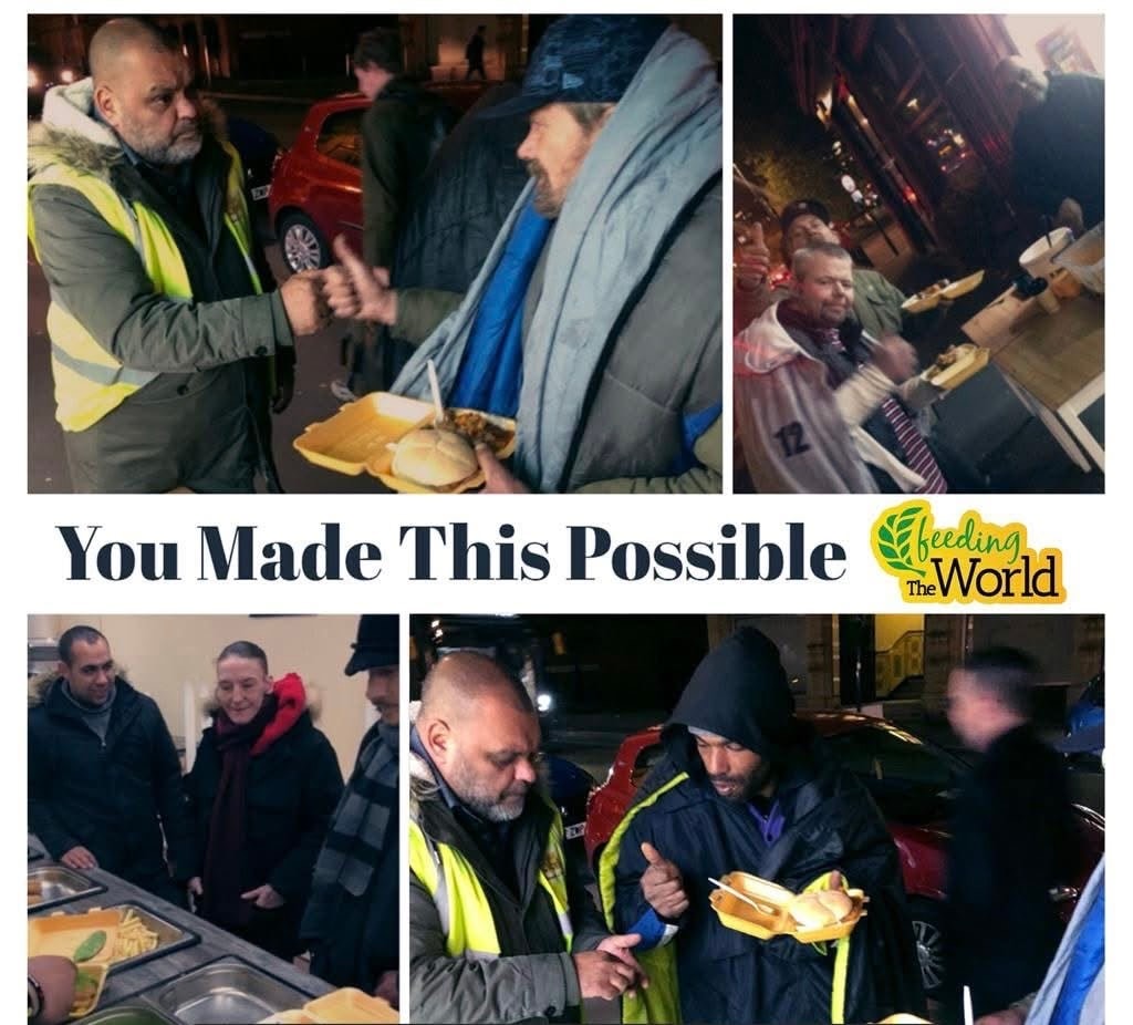 Volunteers distributing hot meals to homeless people on the streets at night